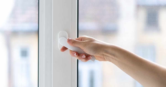 woman closing window with double glazing